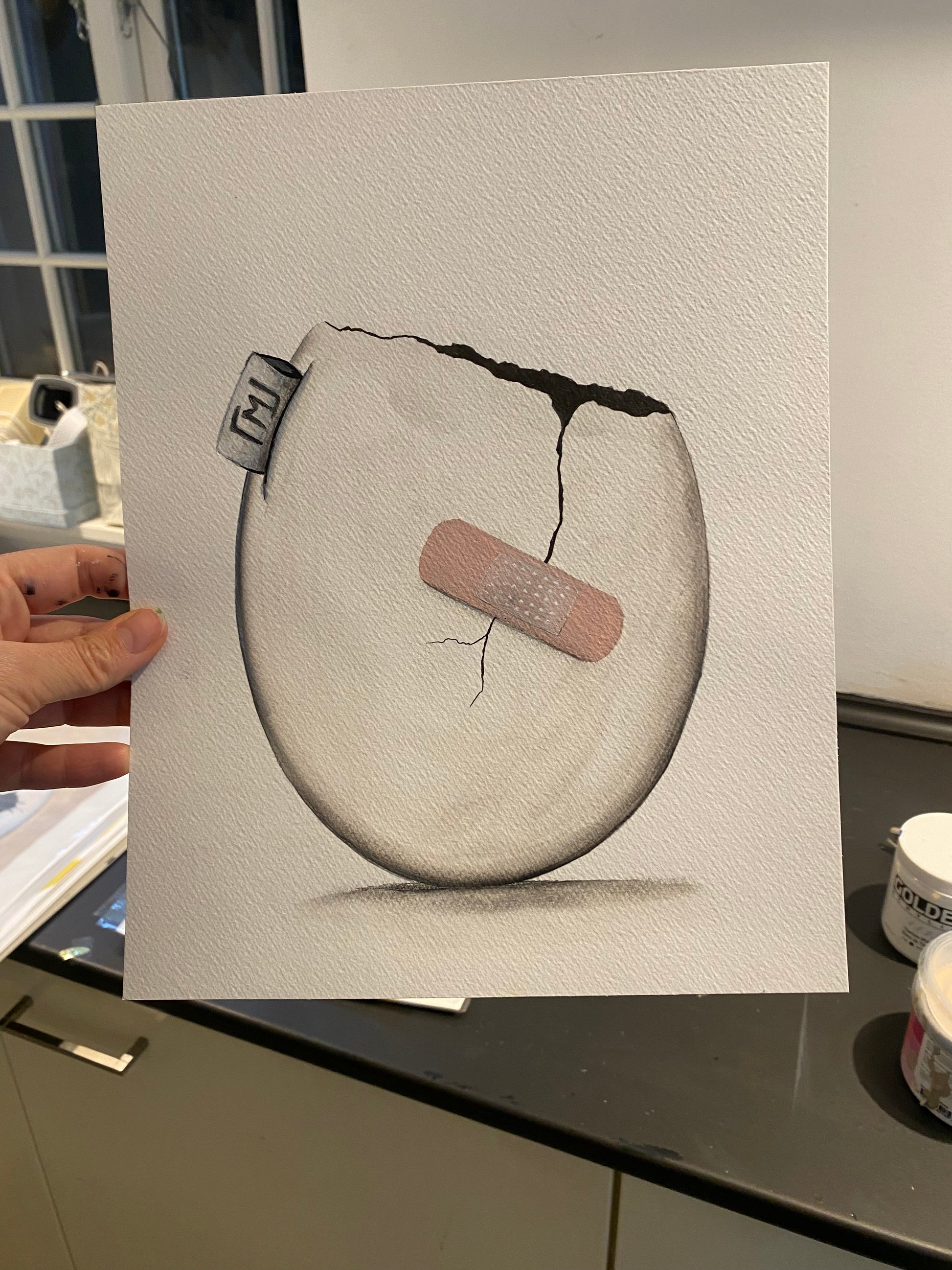 Minimalistisk maleri af æg med revne og plaster, original kunst fra 2022 af Maria Lundsten